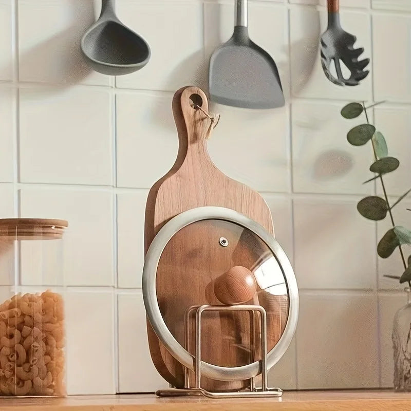 Porta coperchi in acciaio inox con un coperchio di vetro e un tagliere in piedi