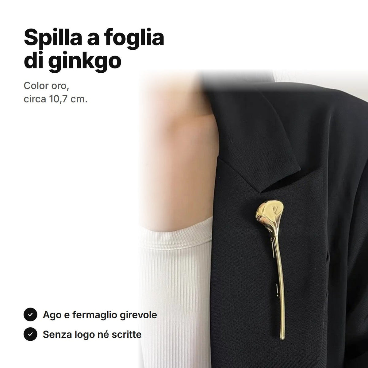Spilla color oro a forma di foglia di ginkgo appuntata su una giacca nera