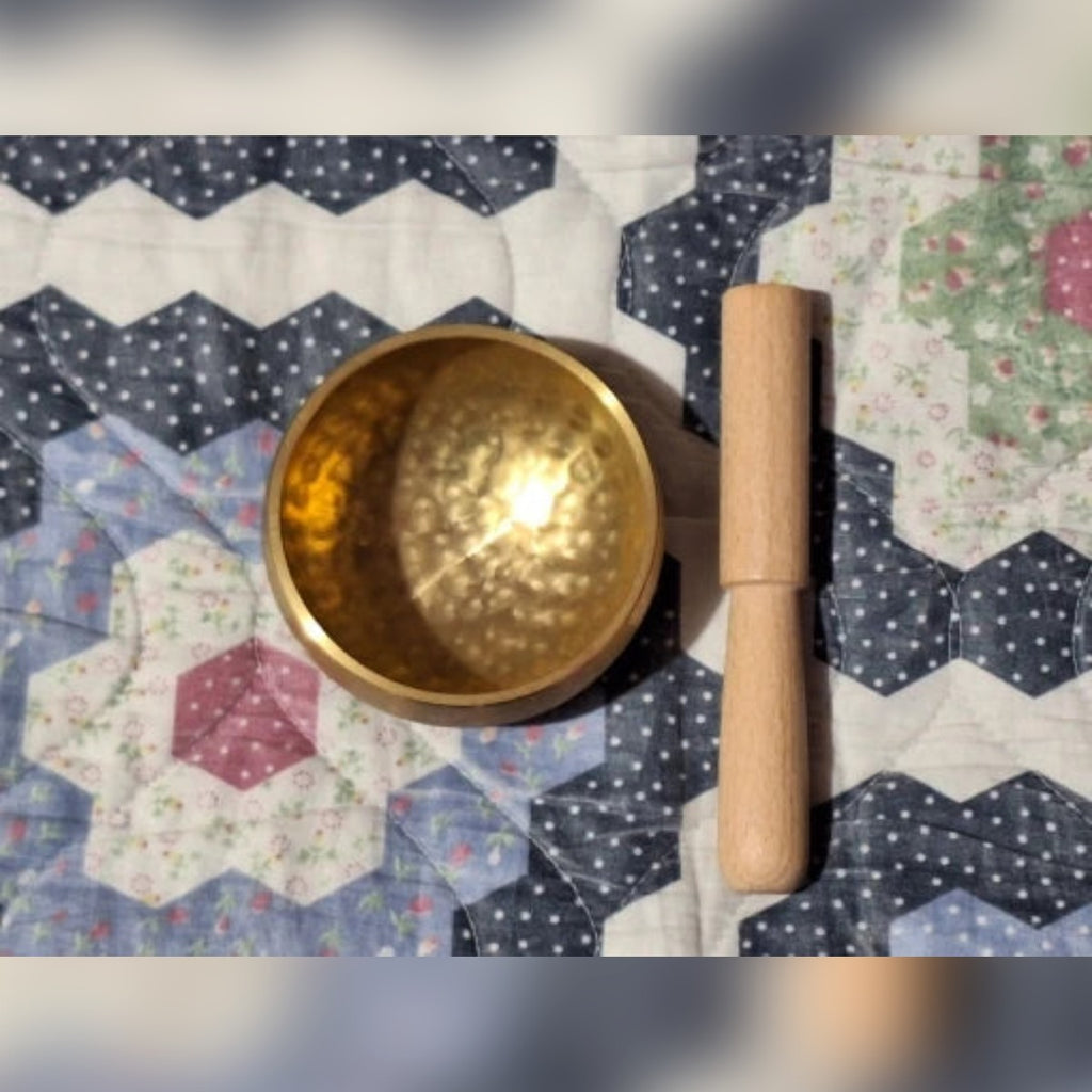 Foto di un cliente: campana e bacchetta su una trapunta