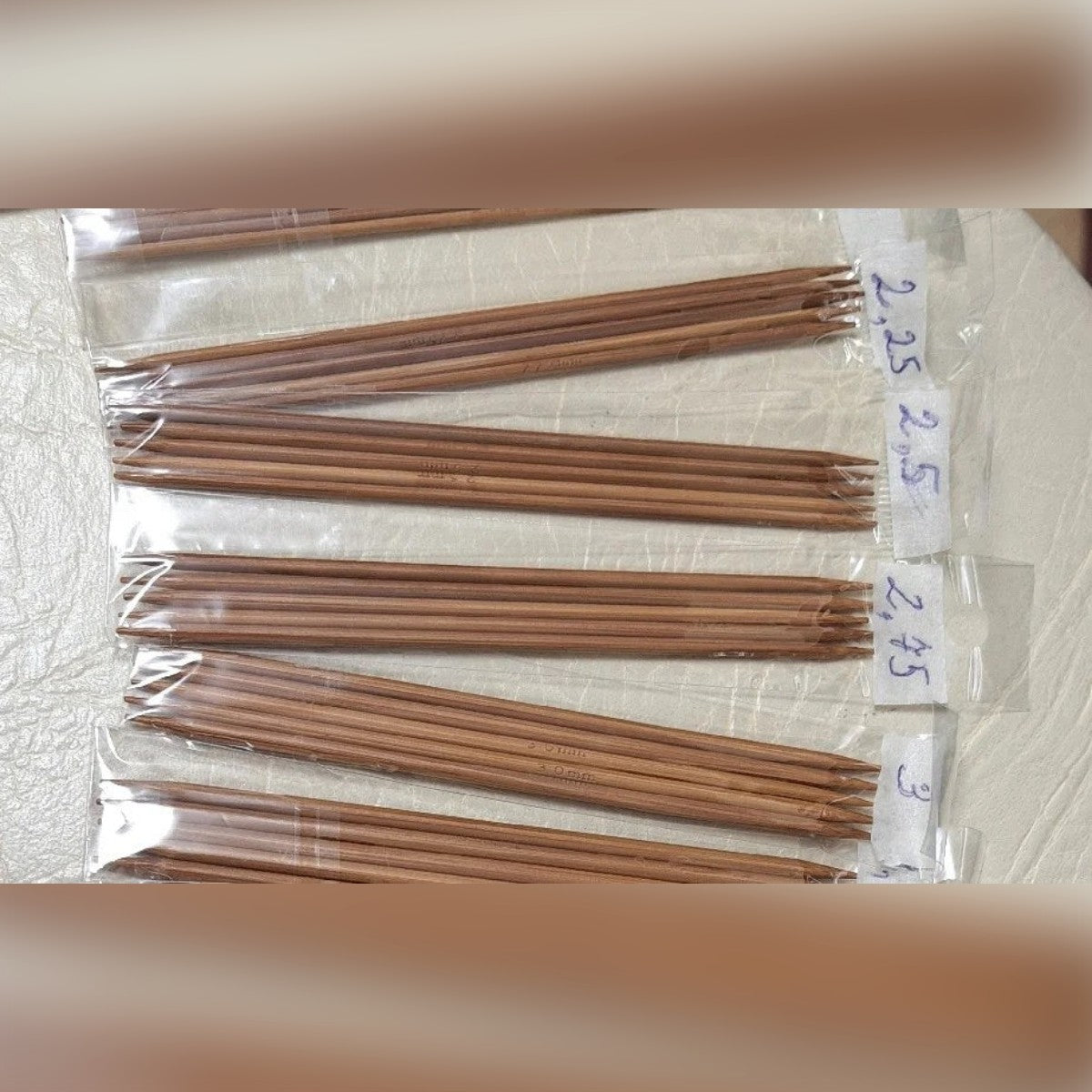 Foto di una cliente: i ferri in bustine separate, ognuna con un'etichetta scritta a mano con la misura in mm